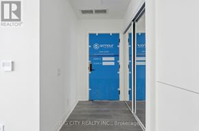 Toronto (Leaside) condo for rent - A hallway with a blue door and a sign that says Armour.