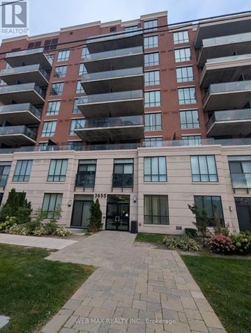 Toronto (Scarborough Village) condo for rent - A red brick building with a black door and windows.