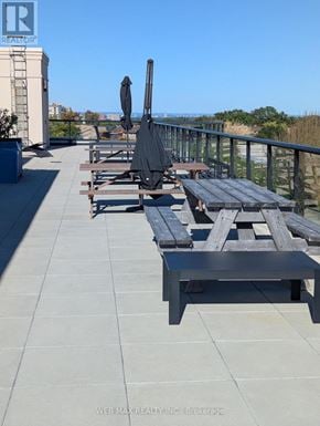 Toronto (Scarborough Village) condo for rent - A patio with a table and chairs overlooking a cityscape.