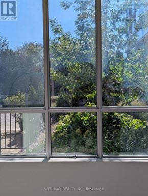 Toronto (Scarborough Village) condo for rent - A window with a view of a garden outside.