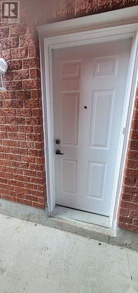 Brampton (Bram East) apartment for rent - A brokerage office with a blue rug and a white door.
