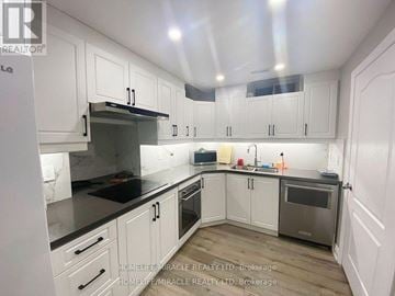 Brampton (Bram East) apartment for rent - A kitchen with white cabinets and a stainless steel oven.