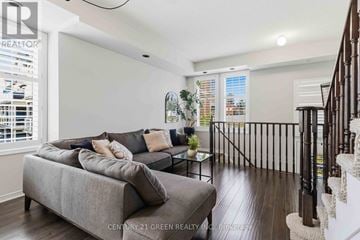 Brampton (Westgate) townhouse for rent - A living room with a grey couch and a glass coffee table.