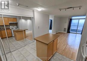Mississauga (City Centre) condo for rent - A kitchen area with wooden cabinets and a countertop is shown in the image.