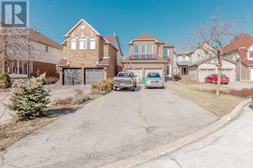 Mississauga (Central Erin Mills) apartment for rent - A residential street with houses and parked cars.