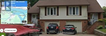 Niagara Falls (Chippawa) apartment for rent - A house with a garage and two cars parked in front.