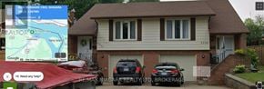 Niagara Falls (Chippawa) apartment for rent - A house with a sign that says "RE/MAX NIAGARA REALTY LTD, BROKERAGE" in front of it.