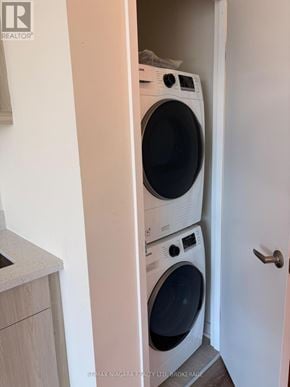 Welland (Broadway) condo for rent - A white washing machine and dryer in a small laundry room.