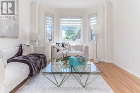 Brampton (Sandringham-Wellington) apartment for rent - A living room with a glass coffee table and a white couch.