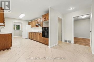 Ottawa apartment for rent - A kitchen with wooden cabinets and a white countertop.