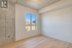 Hamilton (Westdale) condo for rent - A room with a large window and a view of a building outside.