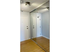 Richmond apartment for rent - A bedroom with a mirrored closet door and wooden floors.