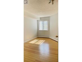 Richmond apartment for rent - A room with a window and wooden flooring.