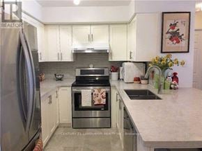 Toronto (Willowdale East) condo for rent - A kitchen with a refrigerator, oven, and sink.