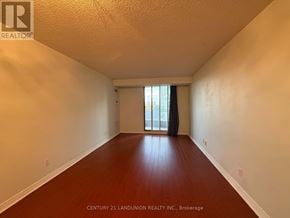 Toronto (Willowdale East) condo for rent - A view of a residential area with a road and houses surrounded by trees.
