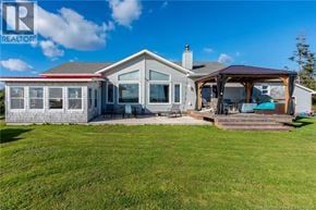 Upper Cape apartment for rent - A house with a large lawn and a deck.