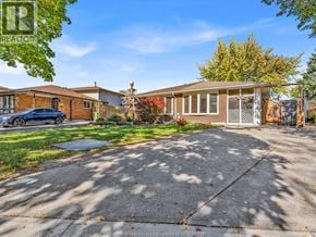 Windsor apartment for rent - A house with a driveway and a car parked in front.