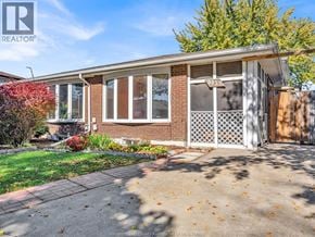 Windsor apartment for rent - A house with a white fence and a brick wall is for sale.