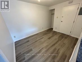 Toronto (Weston-Pellam Park) apartment for rent - A room with wooden flooring and white walls, with a door on the right side.
