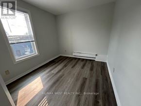 Toronto (Weston-Pellam Park) apartment for rent - A room with a window and a wooden floor.