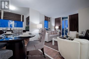 Toronto (Willowdale East) condo for rent - A well-lit living room with a dining table and chairs.