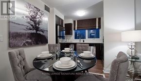 Toronto (Willowdale East) condo for rent - A dining room with a table set for two and a large landscape picture on the wall.