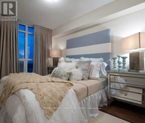 Toronto (Willowdale East) condo for rent - A bedroom with a bed, nightstand, and lamp.