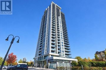 Pickering (Bay Ridges) condo for rent - A tall building with a clear blue sky in the background.