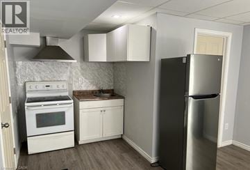 Niagara Falls apartment for rent - A kitchen with a stainless steel refrigerator, oven, and cabinets.