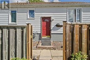 London East (East C) apartment for rent - A small house with a red door is surrounded by a wooden fence.
