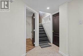 London East (East C) apartment for rent - A hallway with a staircase leading to the second floor.