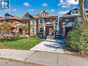 Toronto (Corso Italia-Davenport) triplex for rent - A row of houses with a realtor watermark.