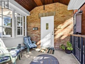 Toronto (Corso Italia-Davenport) triplex for rent - A small patio with a white door and a brick wall.