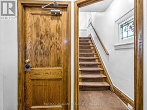 Toronto (Corso Italia-Davenport) triplex for rent - A wooden door with a glass window above it.