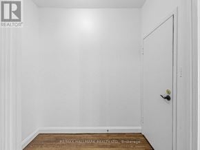 Toronto (Corso Italia-Davenport) triplex for rent - A white door with a black handle is on the right side of the image.