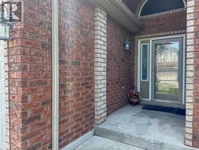 Windsor apartment for rent - A brick house with a glass door and a small window.