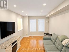 Vaughan (East Woodbridge) townhouse for rent - A living room with a grey couch and a television.