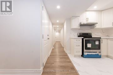 Milton (Fo Ford) apartment for rent - A modern kitchen with white cabinets and a blue appliance.
