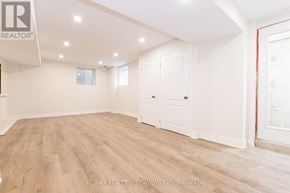 Milton (Fo Ford) apartment for rent - A spacious room with wooden flooring and white walls.