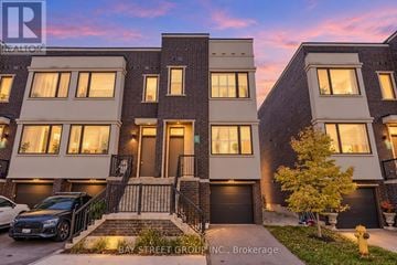 Vaughan (Vellore Village) townhouse for rent - A modern apartment building with a car parked in front.
