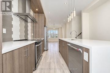 Vaughan (Vellore Village) townhouse for rent - A modern kitchen with wooden cabinets and stainless steel appliances.