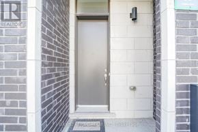 Vaughan (Vellore Village) townhouse for rent - A door with a glass panel is set in a brick wall.