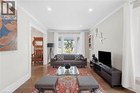 Niagara Falls apartment for rent - A living room with a grey couch and a rug.