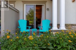 Huntsville (Chaffey) condo for rent - Two turquoise chairs sit on a porch with yellow flowers in front.