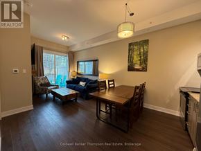 Huntsville (Chaffey) condo for rent - A living room with a couch, chairs, and a dining table.