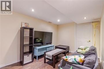 Hamilton apartment for rent - A living room with a grey sofa and a wooden cabinet.