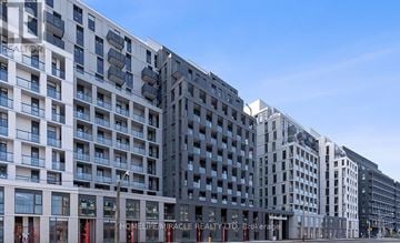 Toronto (Clanton Park) condo for rent - A row of modern buildings with balconies and a clear blue sky.