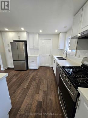 Toronto (L'amoreaux) apartment for rent - A kitchen with white cabinets and a black stove top oven.