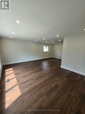 Toronto (L'amoreaux) apartment for rent - A room with wooden flooring and a window letting in sunlight.