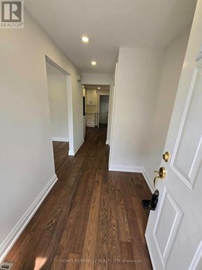 Toronto (L'amoreaux) apartment for rent - A hallway with a wooden floor and white walls.